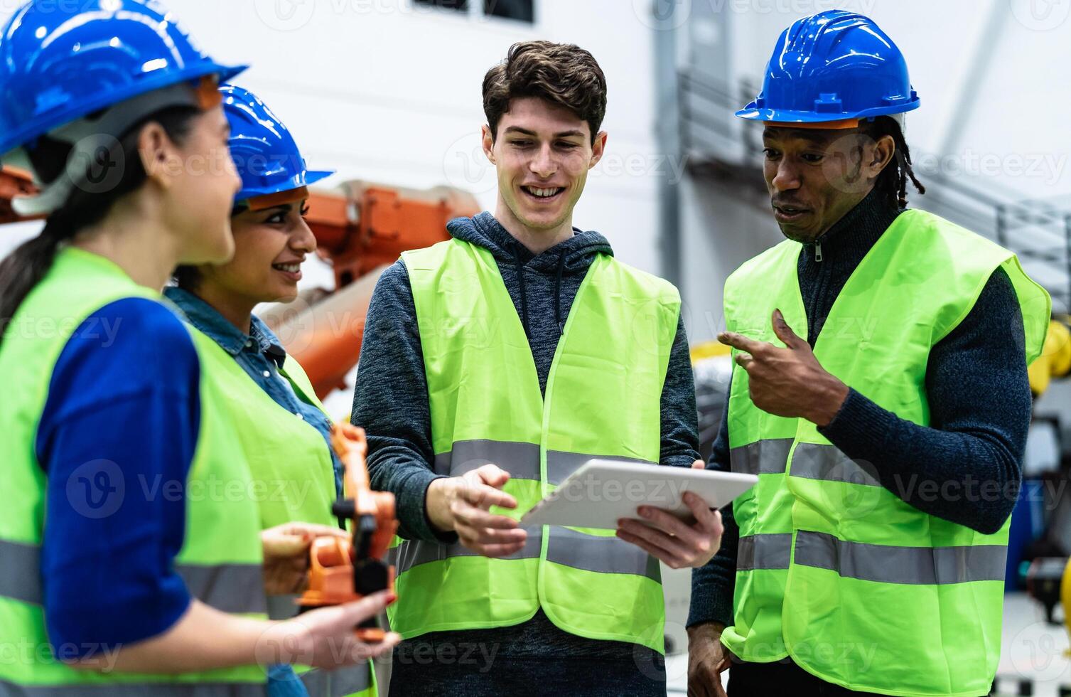 Team of engineers working in robotic factory - Tech industry concept photo