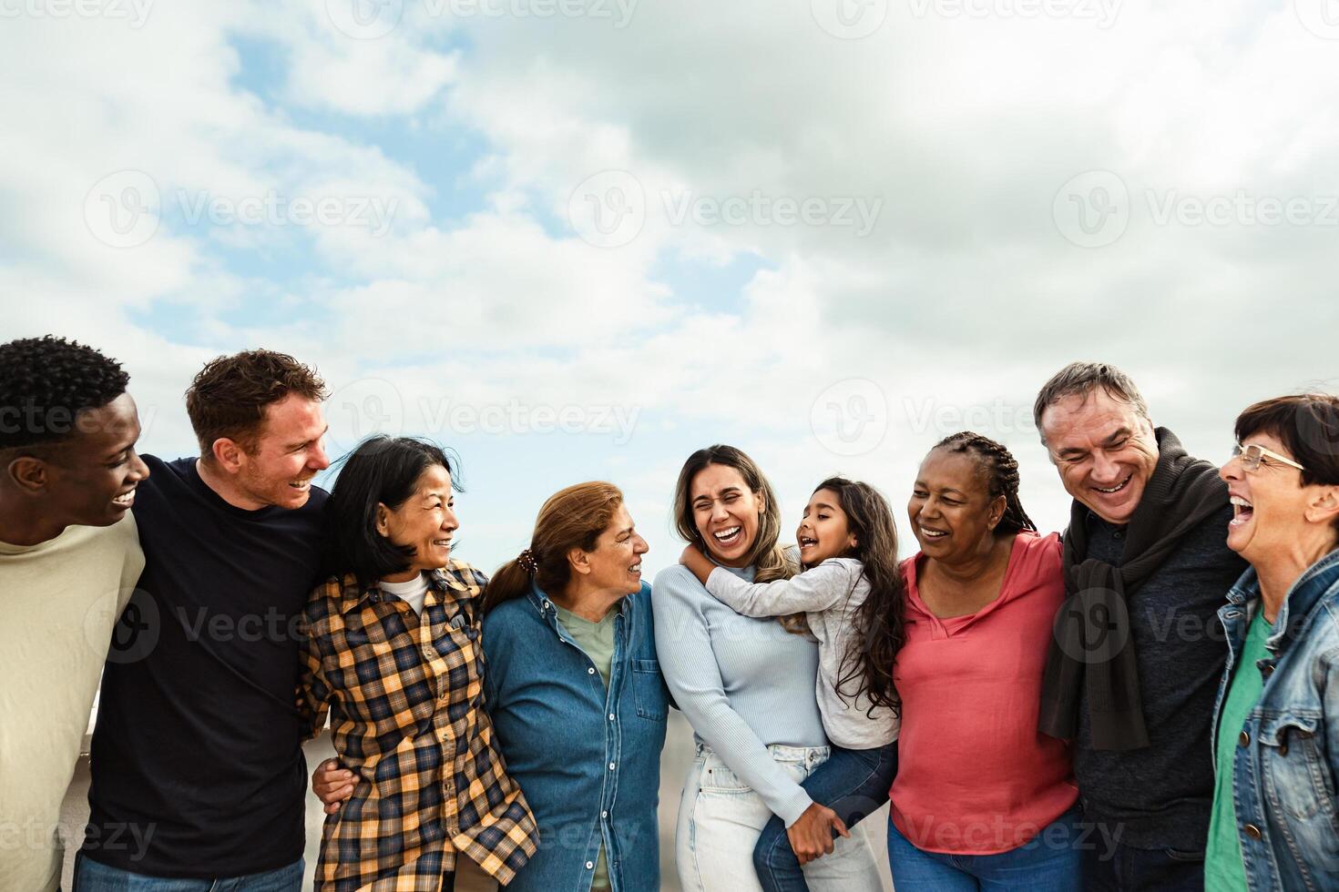 Happy multigenerational friends with different ethnicity having fun at house rooftop - Diversity people lifestyle photo