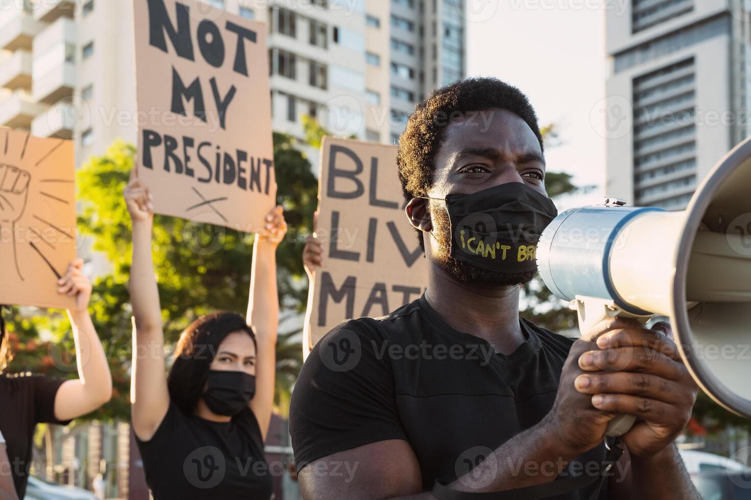 Activist movement protesting against racism and fighting for equality - Demonstrators from different cultures and race protest on street for equal rights - Black lives matter protests city concept photo