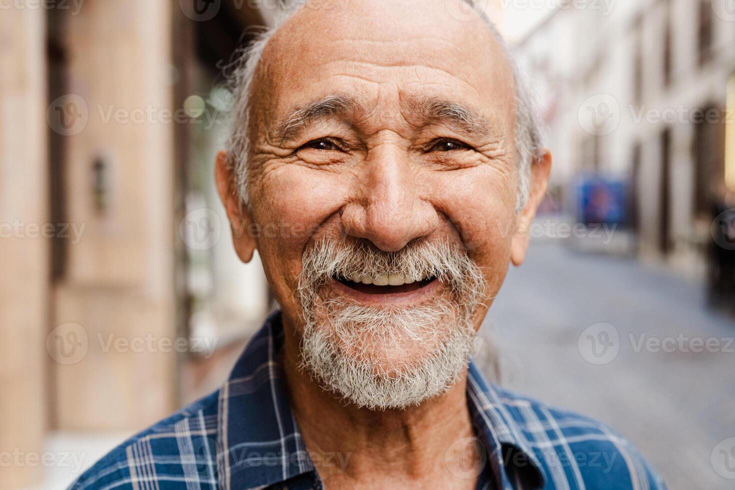 Portrait of happy senior man smiling in front of camera - Elderly people lifestyle concept photo