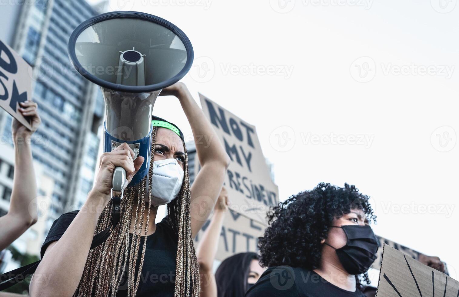 Activist movement protesting against racism and fighting for equality - Demonstrators from different cultures and race protest on street for equal rights - Black lives matter protests city concept photo