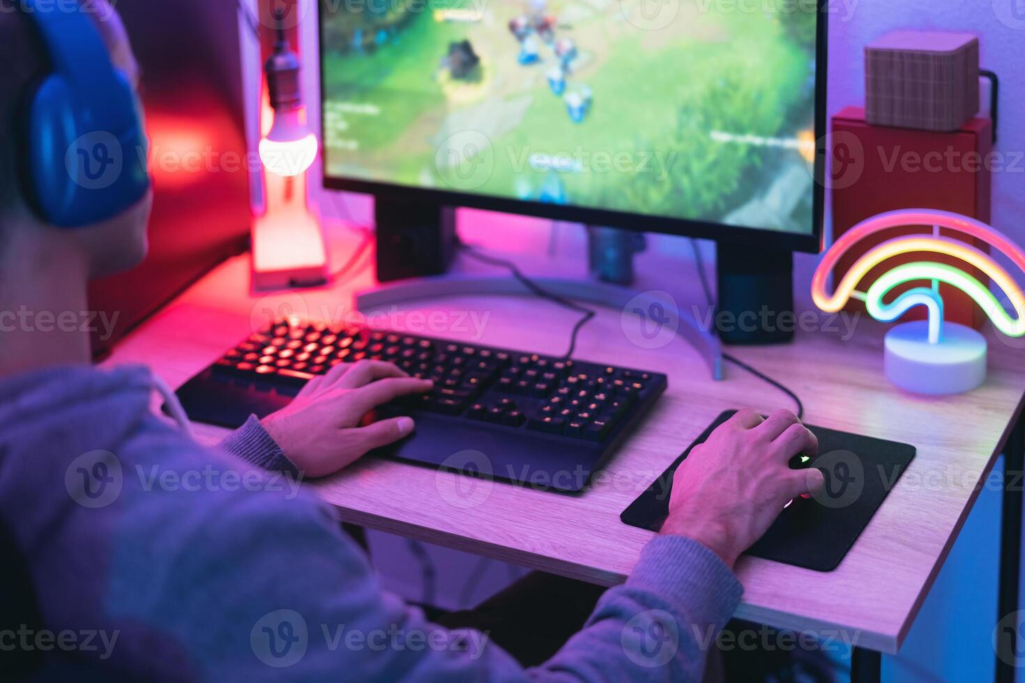 Young gamer playing online video games while streaming on social media - Youth people addicted to new technology game photo