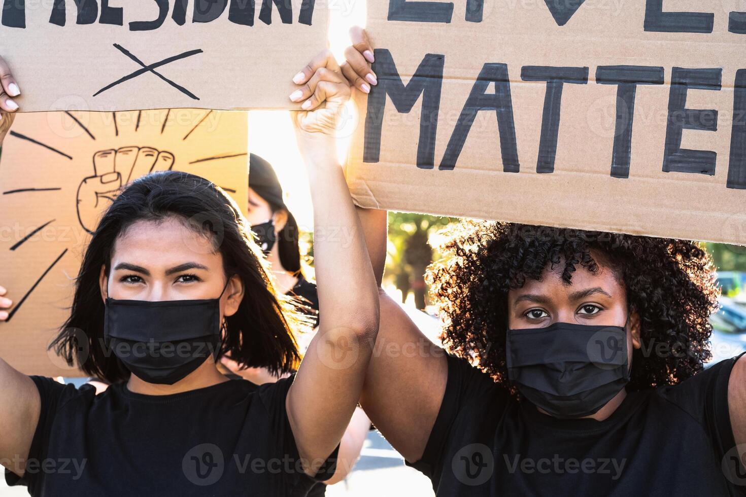 Black lives matter activist movement protesting against racism and fighting for equality - Demonstrators from different cultures and race manifesting on street for justice and equal rights photo