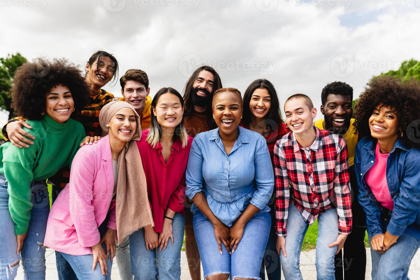 Young multiracial friends having fun together hanging out in the city - Friendship and diversity concept photo