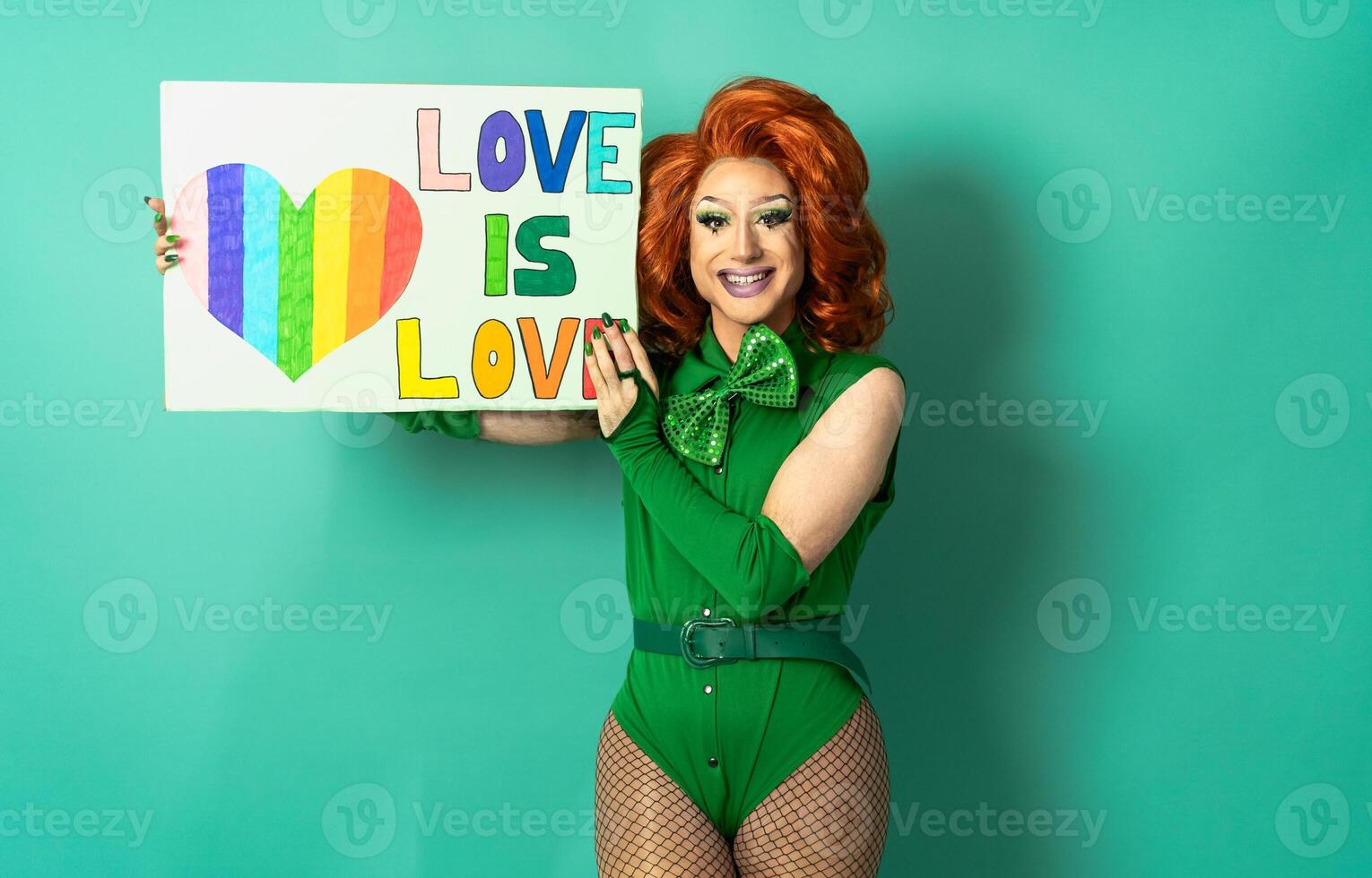 Happy drag queen celebrating gay pride holding banner with rainbow flag - LGBTQ community concept photo