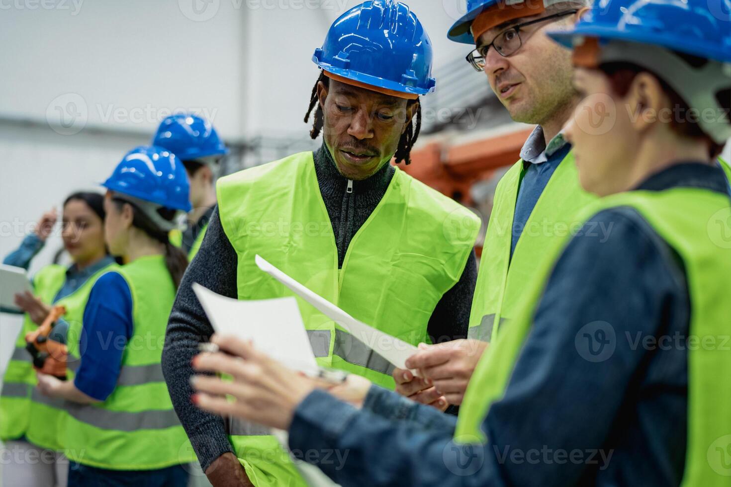 Team of multiracial engineers working in robotic factory - Tech industry concept photo