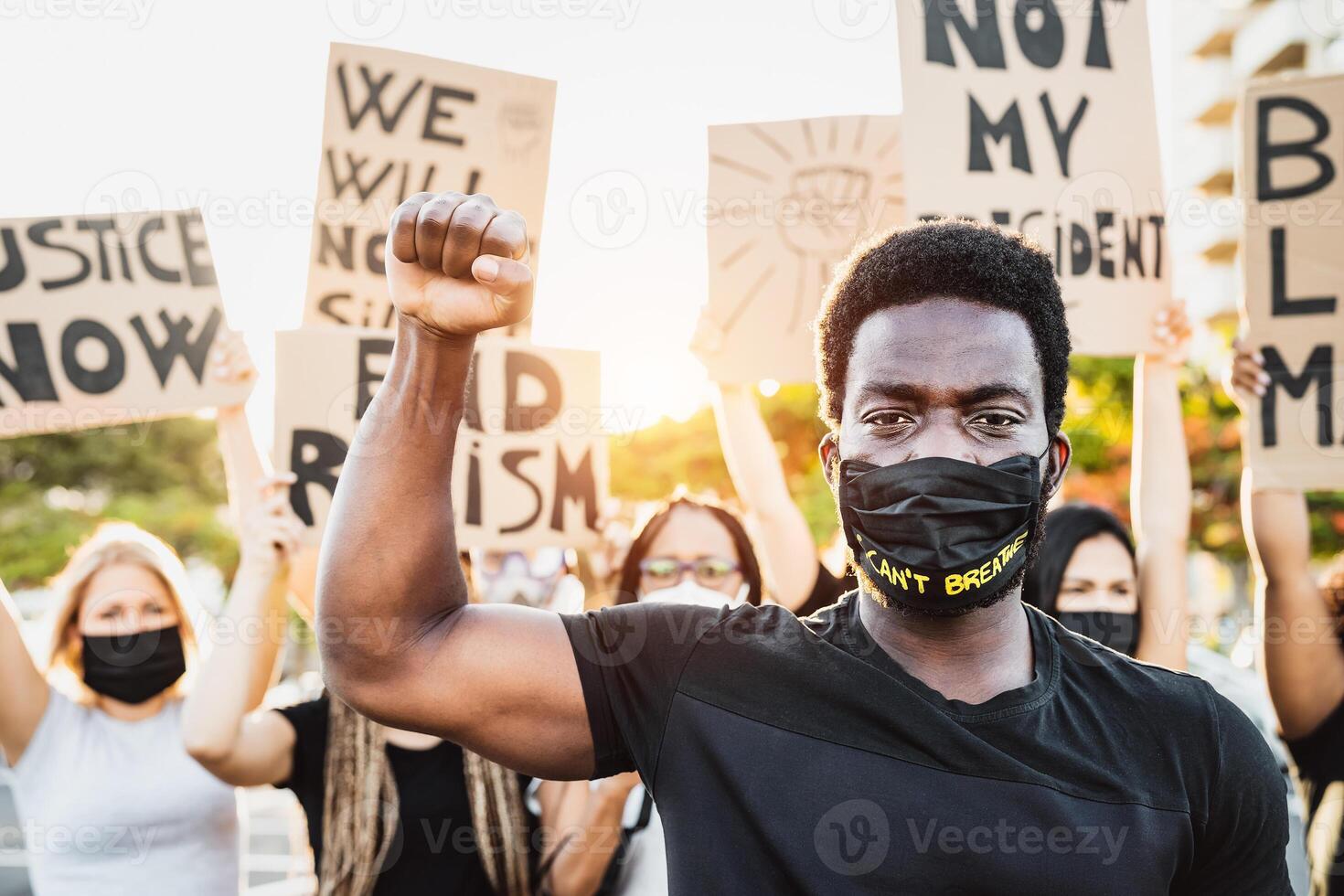 Black lives matter activist movement protesting against racism and fighting for equality - Demonstrators from different cultures and race protest on street for justice and equal rights photo