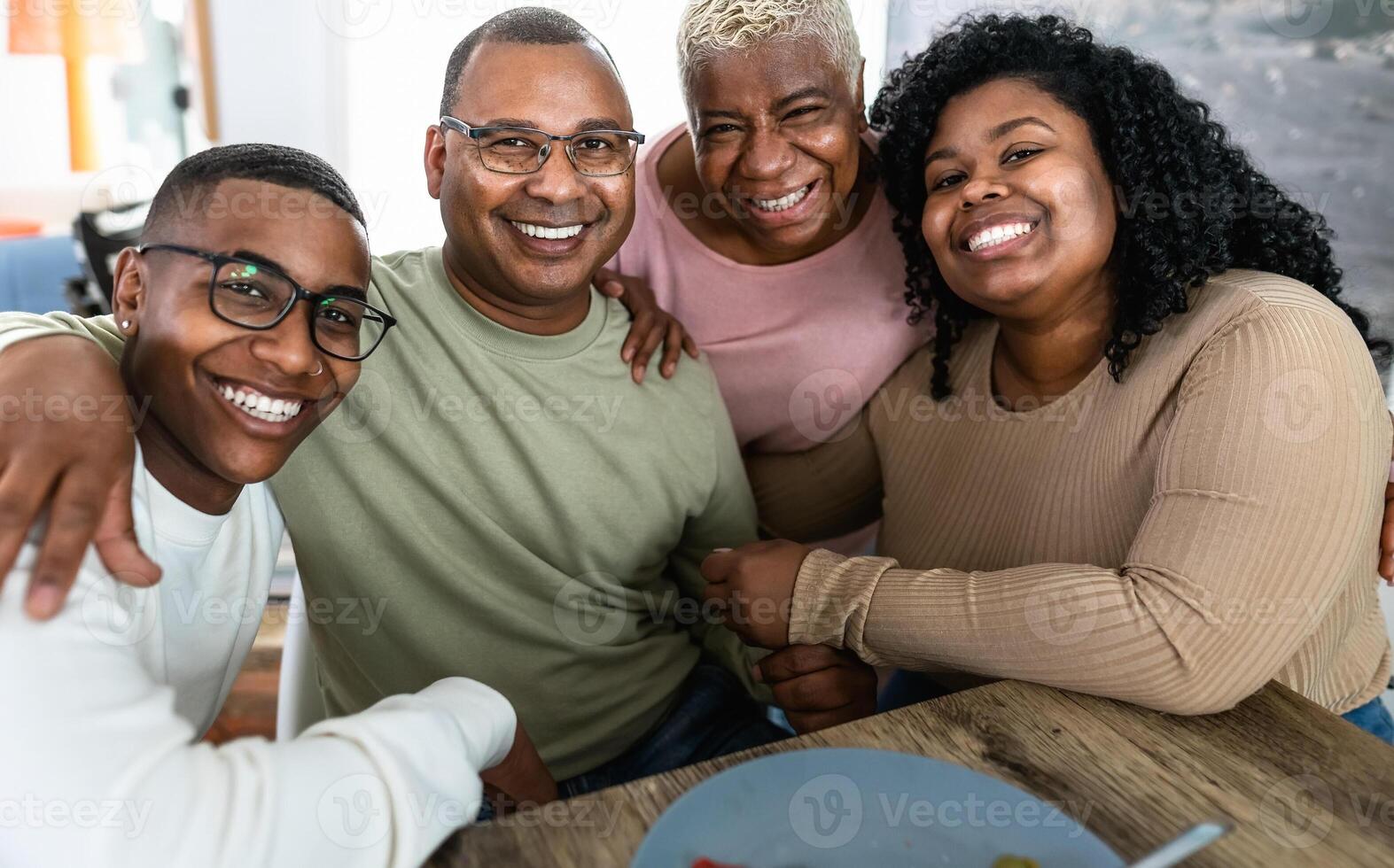 Happy African family having fun after a lunch together at home photo