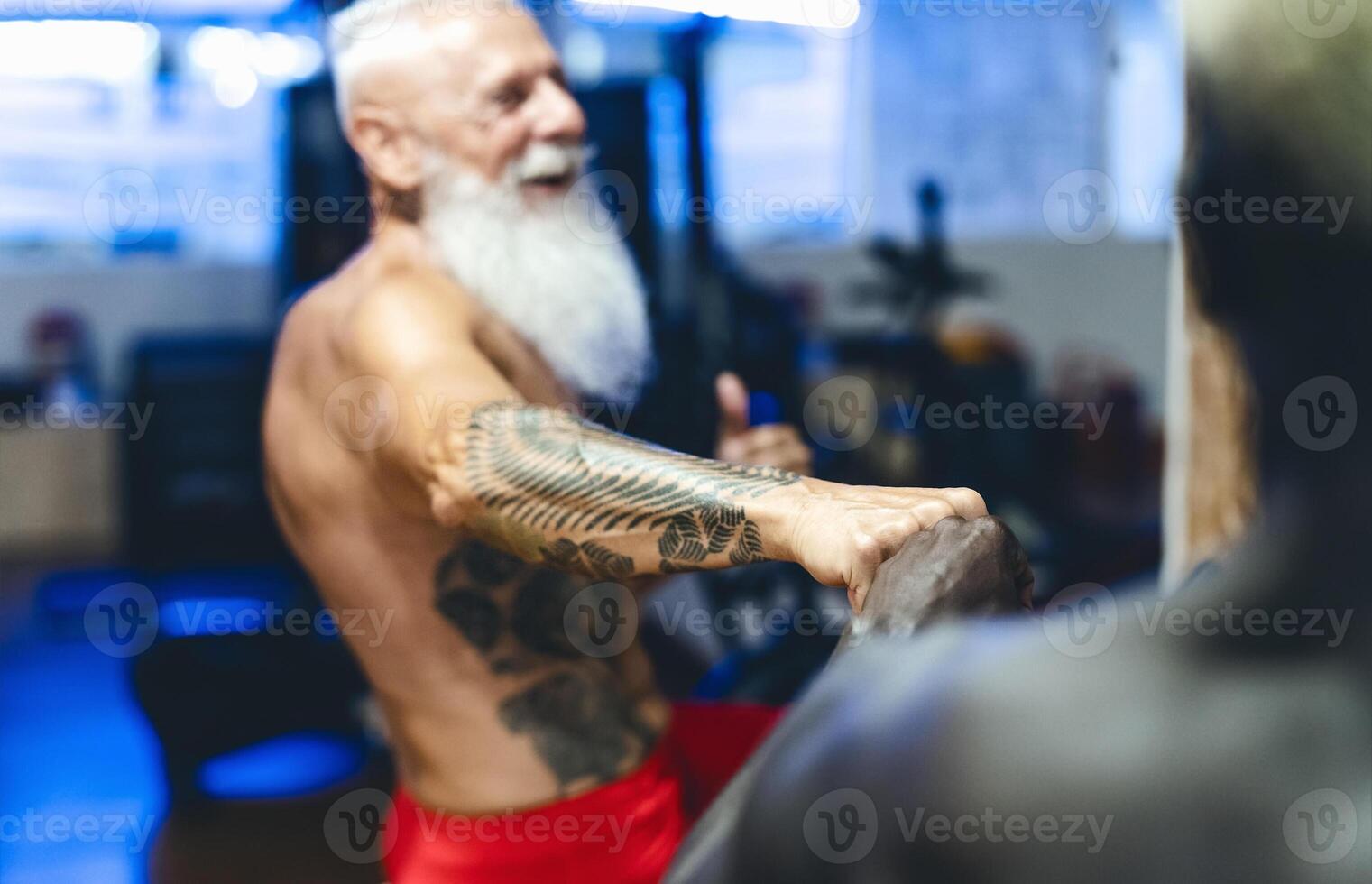Athletes with different age and race doing bike exercises in gym - Fit people training on cycling machine in health wellness center - Sport activity and fitness lifestyle concept photo