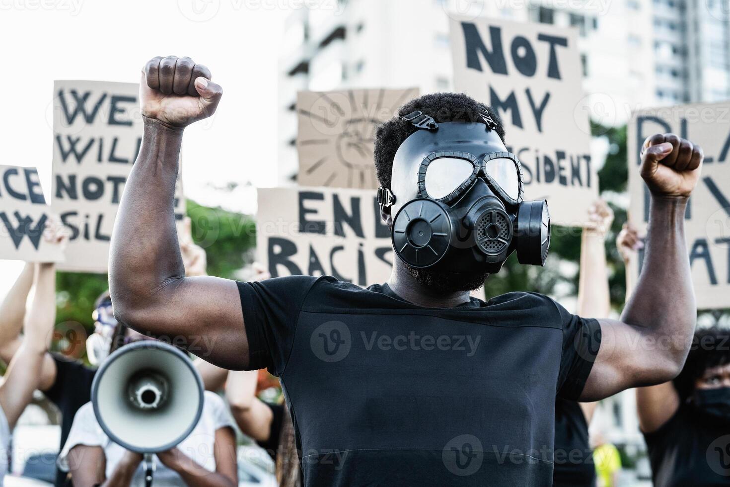 Activist wearing gas mask protesting against racism and fighting for equality - Black lives matter demonstration on street for justice and equal rights - Blm international movement concept photo