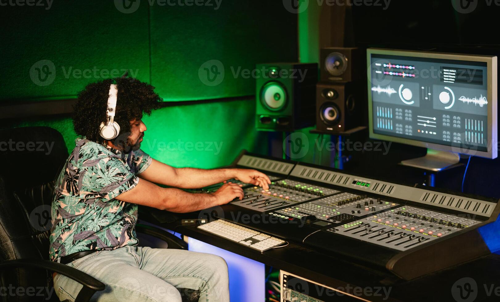 Young audio engineer mixing a sounds in music recording studio - Youth musician people lifestyle concept photo