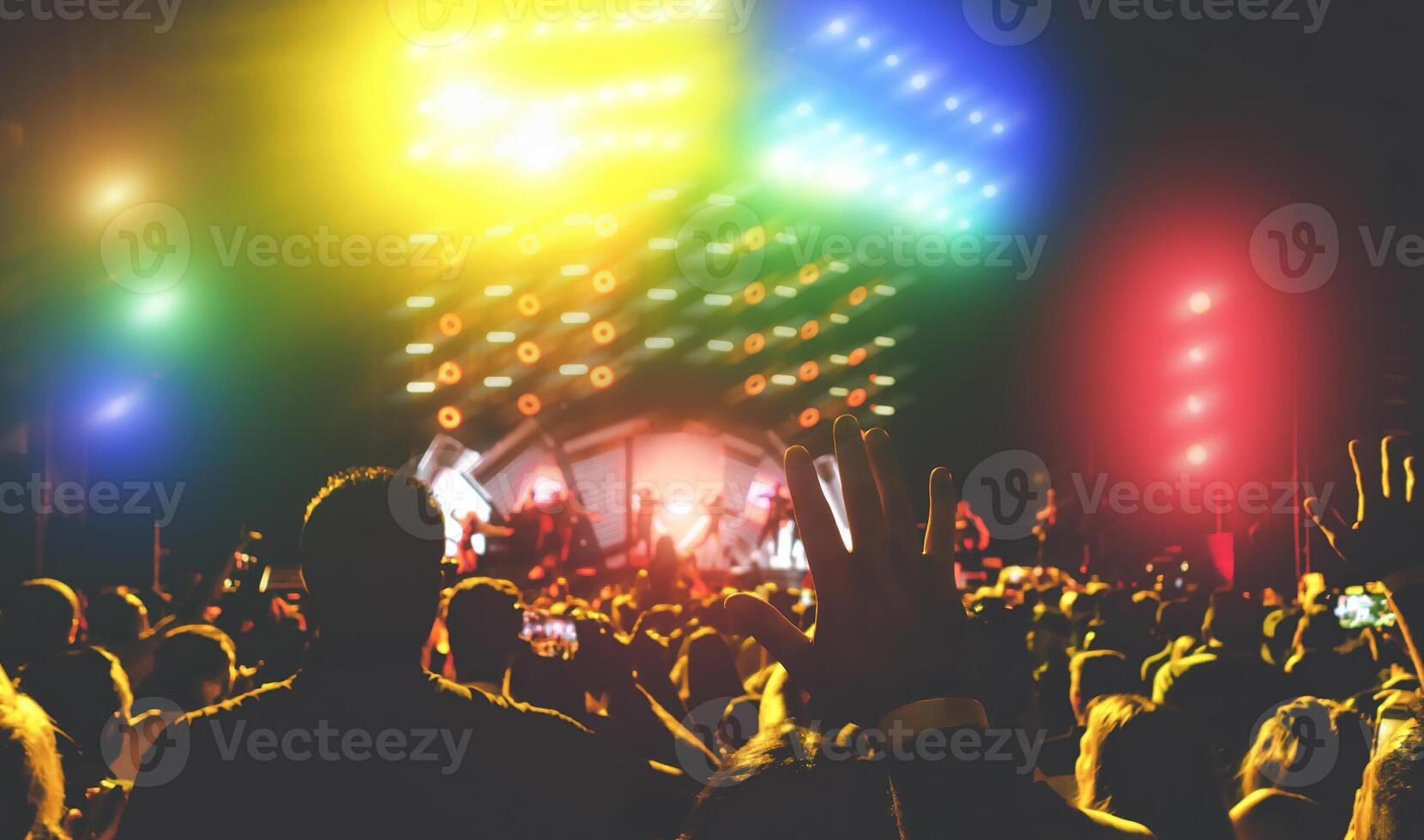 Young people dancing and having fun in music festival party outdoor - Crowd with hands up celebrating concert fest event - Disco club entertainment and youth culture lifestyle concept photo