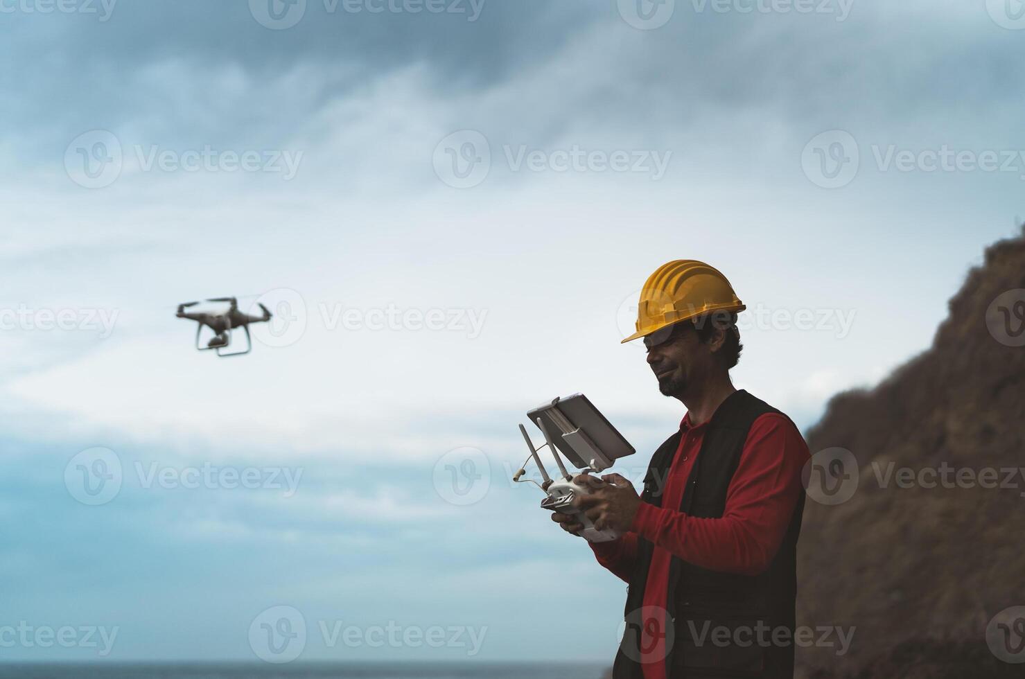 Male engineer doing inspection using drone - Technology and industrial concept photo