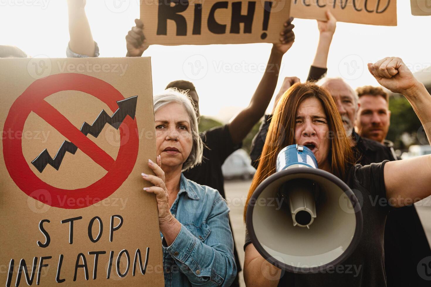 Multiracial people protesting against financial crisis and global inflation - Economic justice activism concept photo