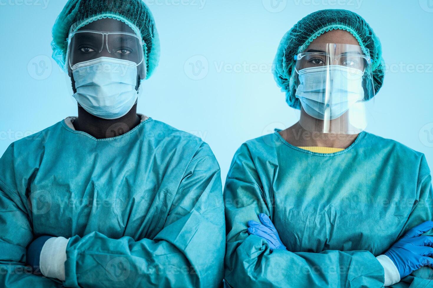 Multiracial doctors wearing personal protective equipment fighting against corona virus outbreak - Health care and medical workers concept photo