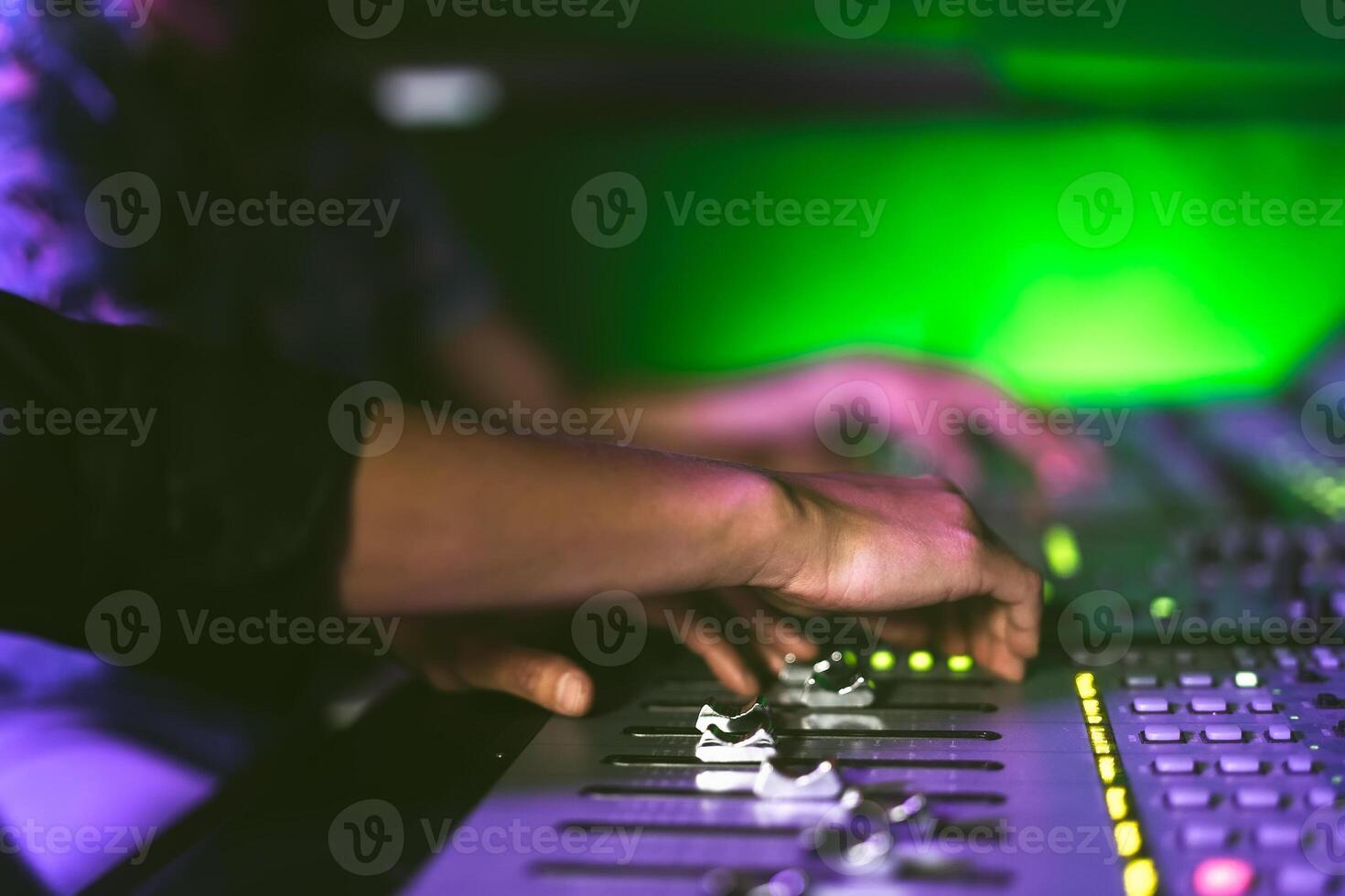 Close up audio engineer working with panel mixer control in music recording studio photo