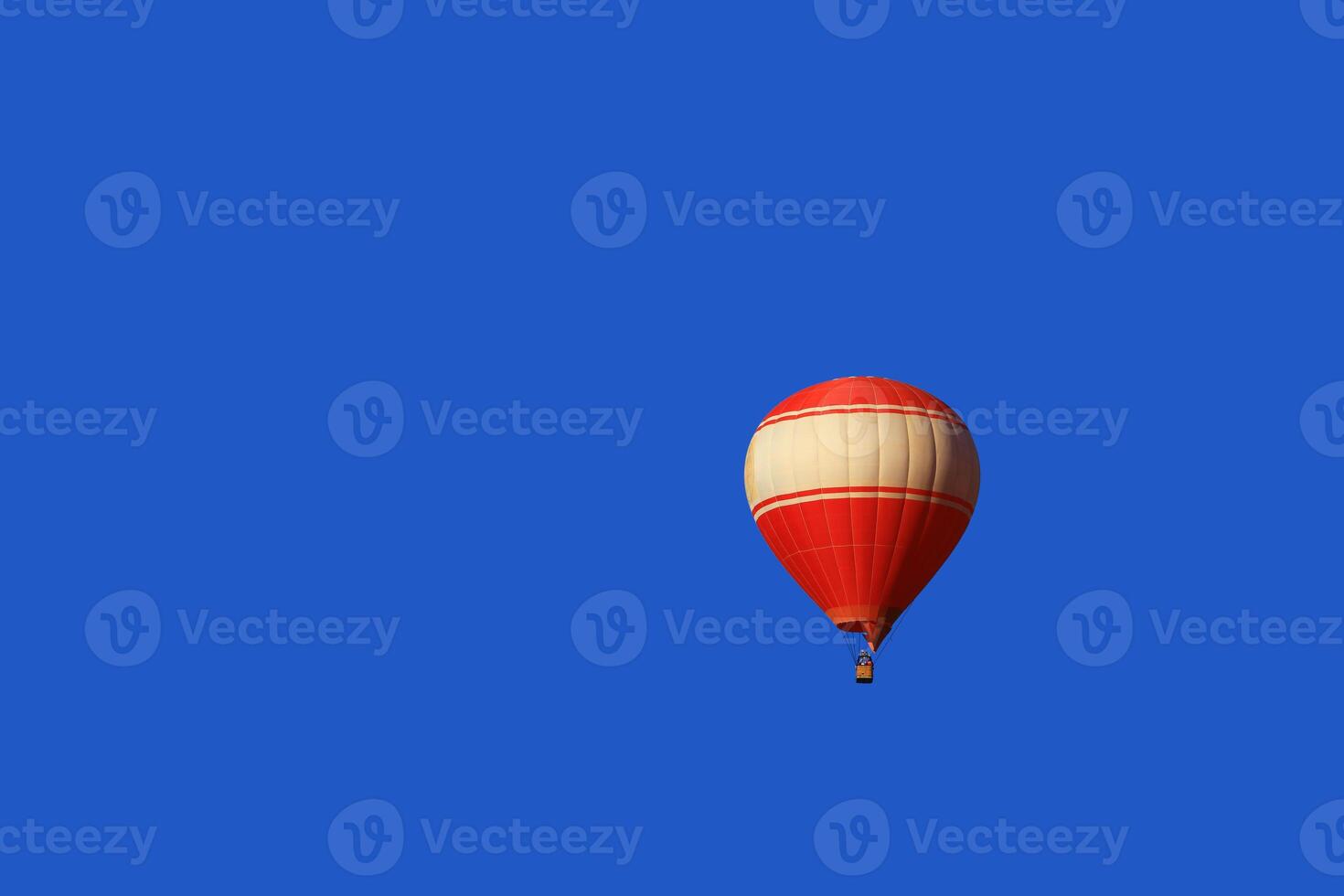 A red balloon floats on blue sky background in Vang Vieng, Laos photo