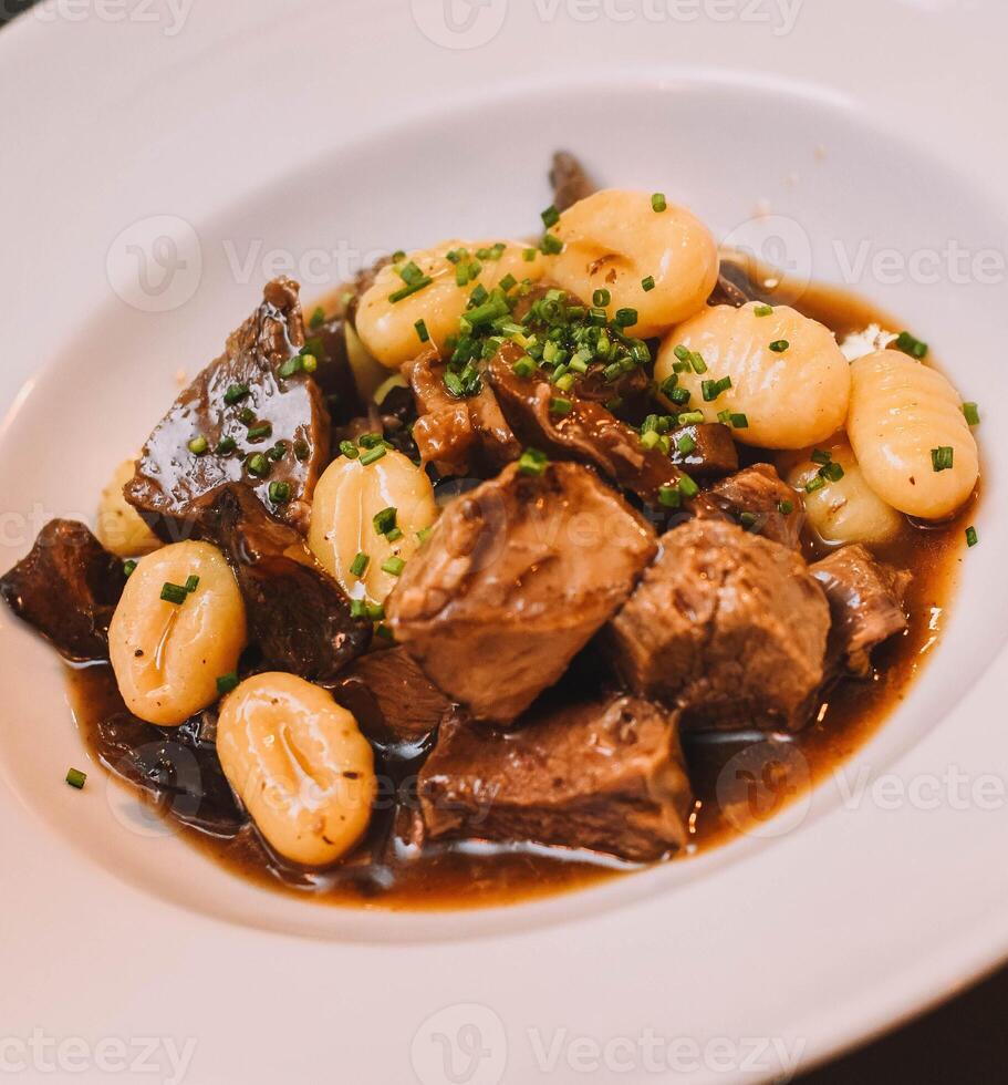 Gourmet gnocchi dish with beef ragu photo