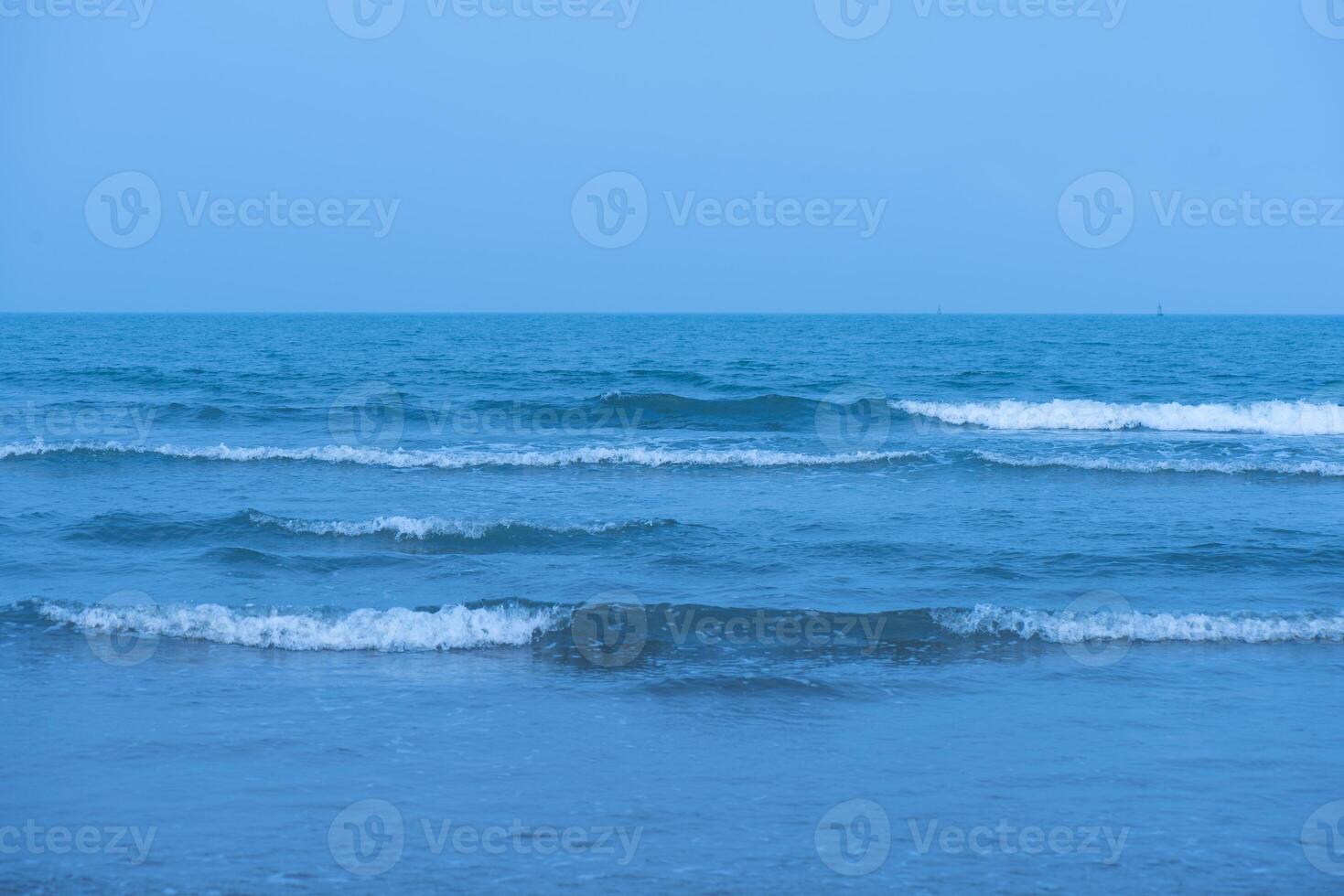 Waves on the beach. Blue sea wave. Blue water surface texture with ripples, splashes, and bubbles. Abstract summer banner background Water waves in sunlight with copy space cosmetic moisturizer. photo
