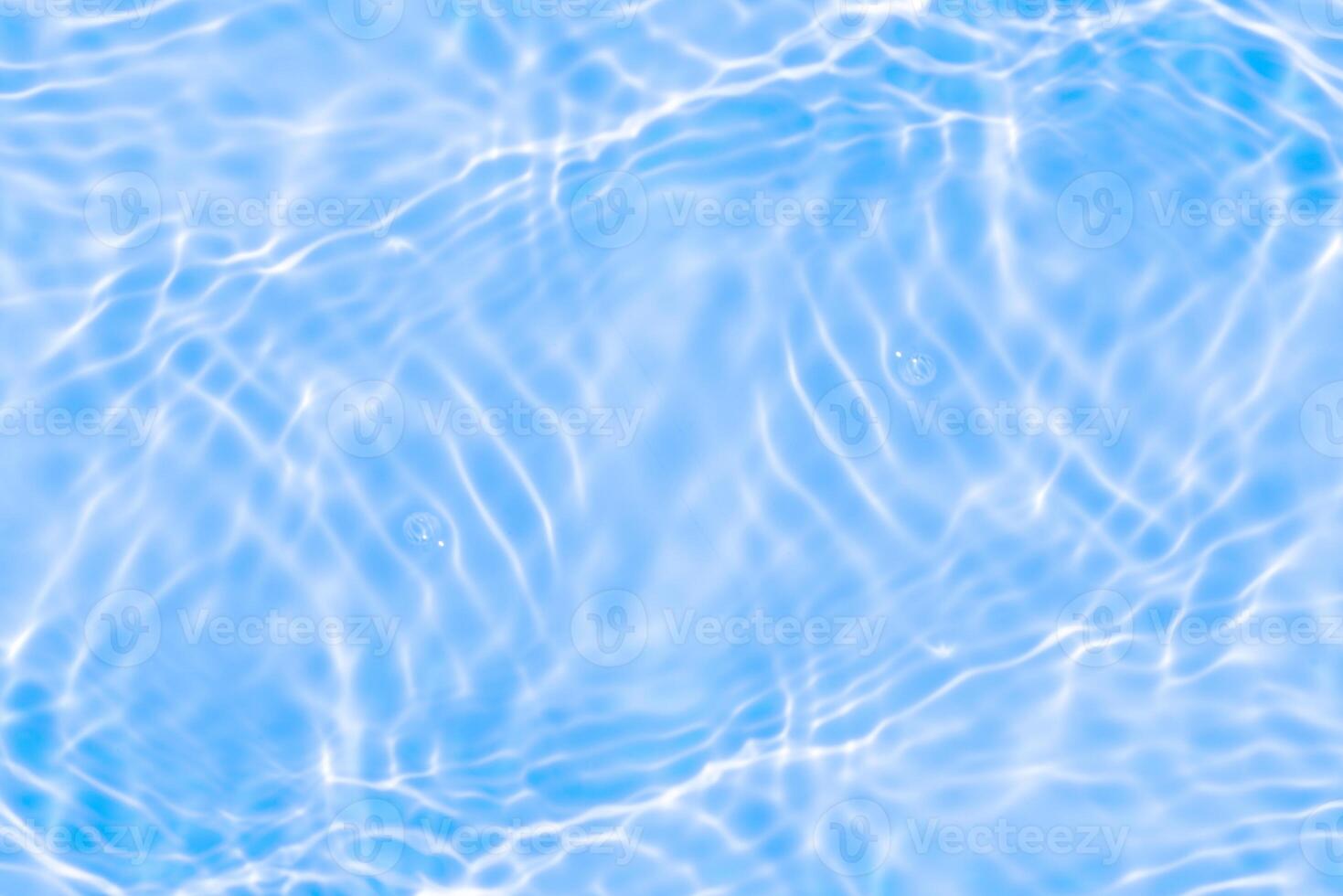 Bluewater waves on the surface ripples blurred. Defocus blurred transparent blue colored clear calm water surface texture with splash and bubbles. Water waves with shining pattern texture background. photo