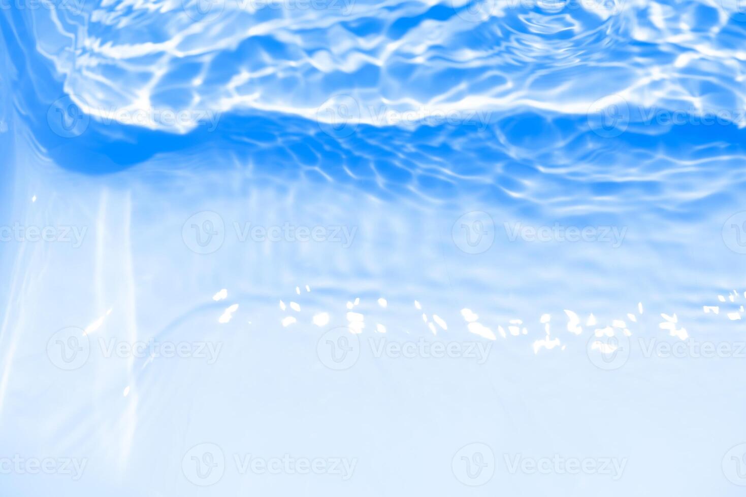 Bluewater waves on the surface ripples blurred. Defocus blurred transparent blue colored clear calm water surface texture with splash and bubbles. Water waves with shining pattern texture background. photo