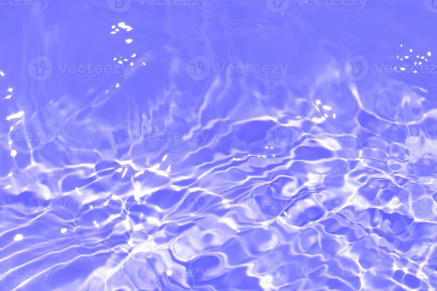 Bluewater waves on the surface ripples blurred. Defocus blurred transparent blue colored clear calm water surface texture with splash and bubbles. Water waves with shining pattern texture background. photo