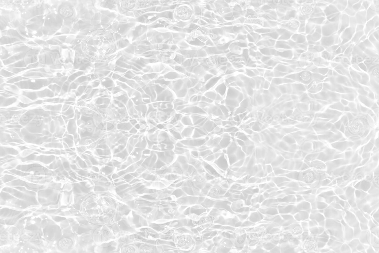 White water with ripples on the surface. Defocus blurred transparent white colored clear calm water surface texture with splashes and bubbles. Water waves with shining pattern texture background. photo