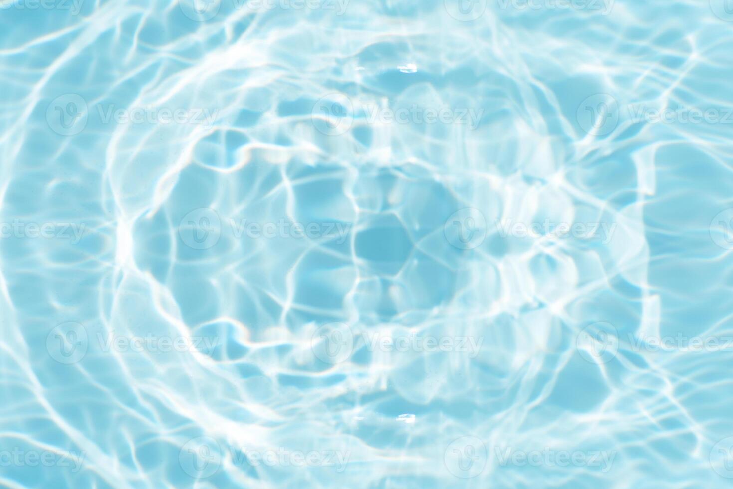 Bluewater waves on the surface ripples blurred. Defocus blurred transparent blue colored clear calm water surface texture with splash and bubbles. Water waves with shining pattern texture background. photo