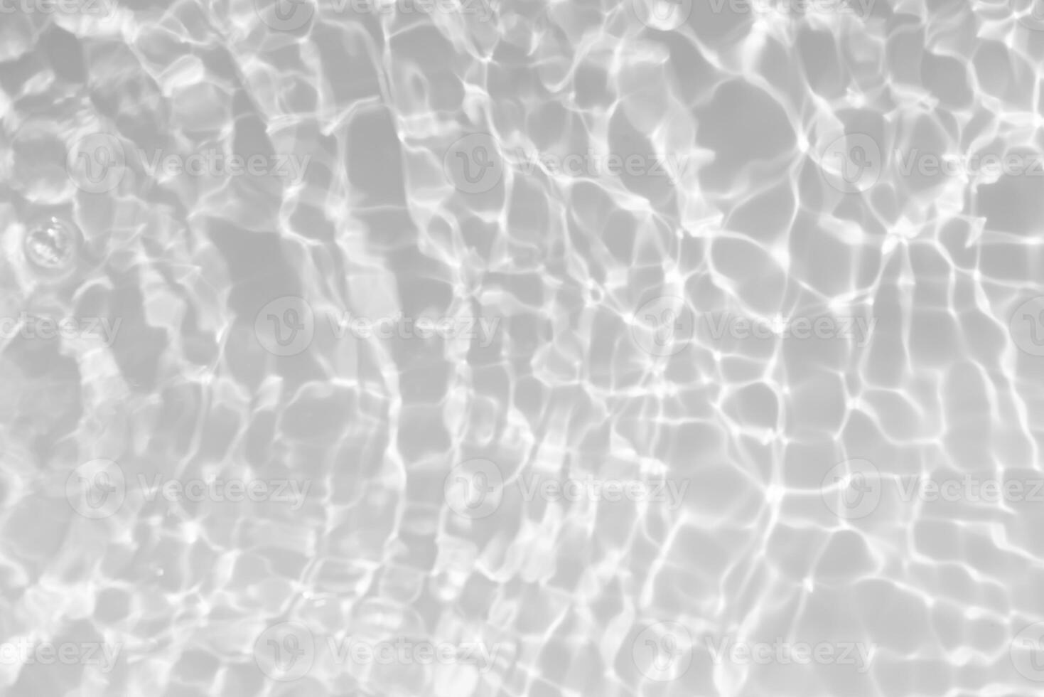 Bluewater waves on the surface ripples blurred. Defocus blurred transparent blue colored clear calm water surface texture with splash and bubbles. Water waves with shining pattern texture background. photo