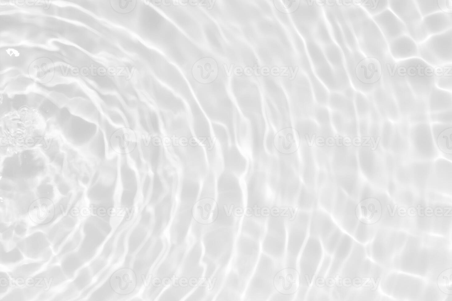 Bluewater waves on the surface ripples blurred. Defocus blurred transparent blue colored clear calm water surface texture with splash and bubbles. Water waves with shining pattern texture background. photo