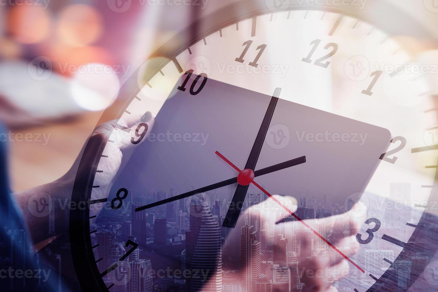 Working hours and working overtime. Close-up view of an employee typing on tablet with clock overlapping. concept of effective time management photo