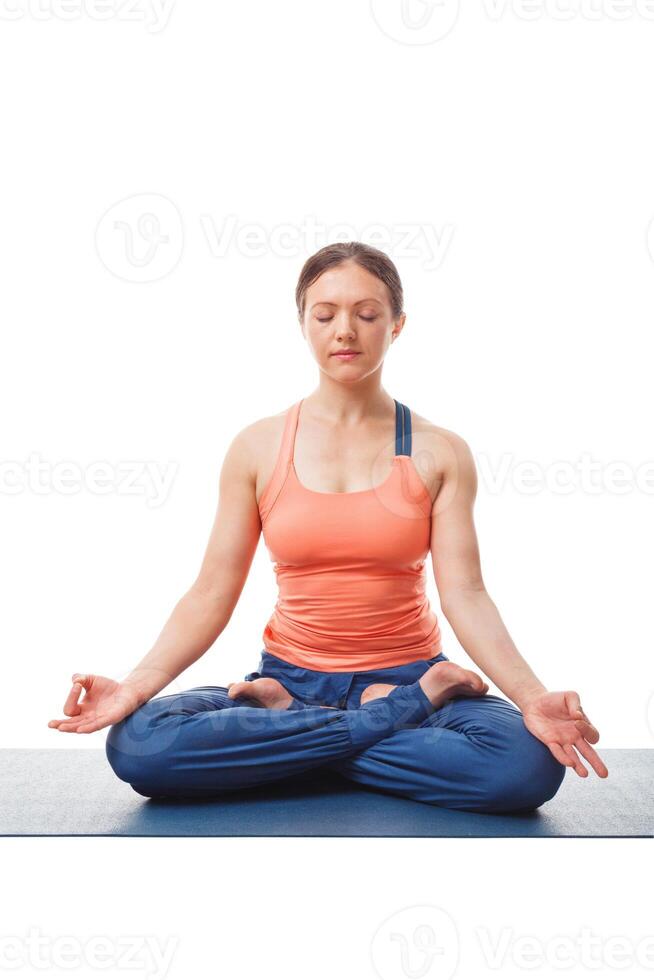 Woman meditating in yoga asana Padmasana Lotus pose photo