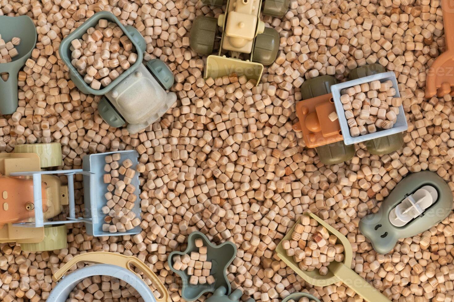 A modern children's sandbox with toys. Sandbox filler in the form of wooden small wooden cubes photo