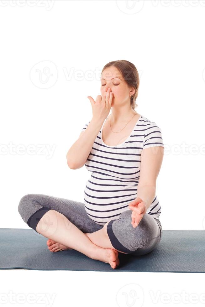 Pregnant woman doing yoga breathing exercise Pranayama photo