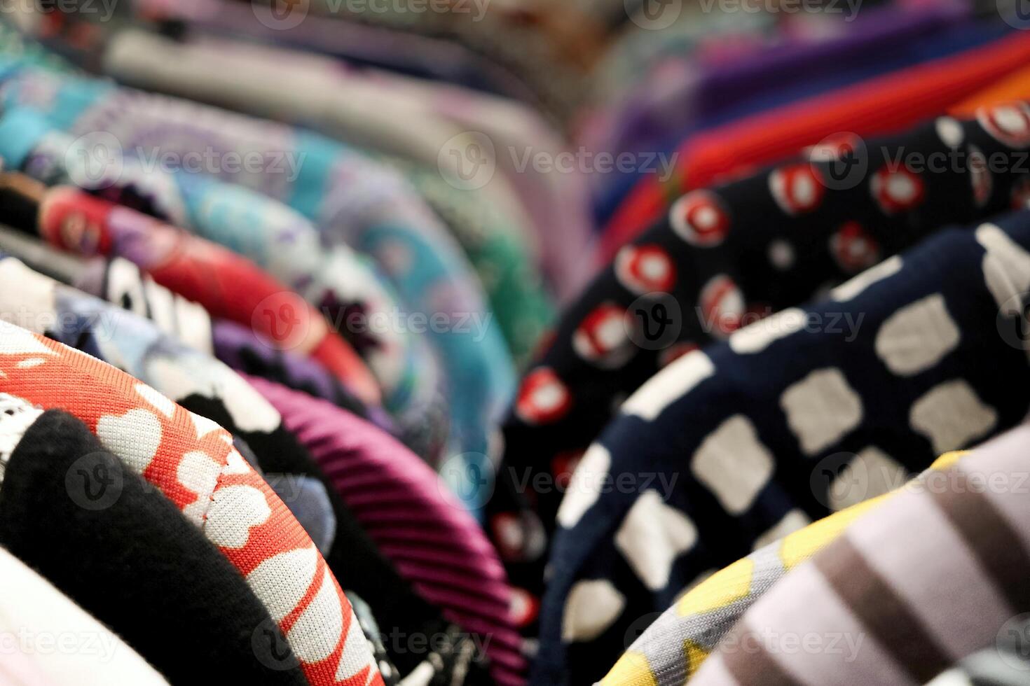 A row of clothes hanging on a rack in a store. Suitable for fashion and retail concepts photo