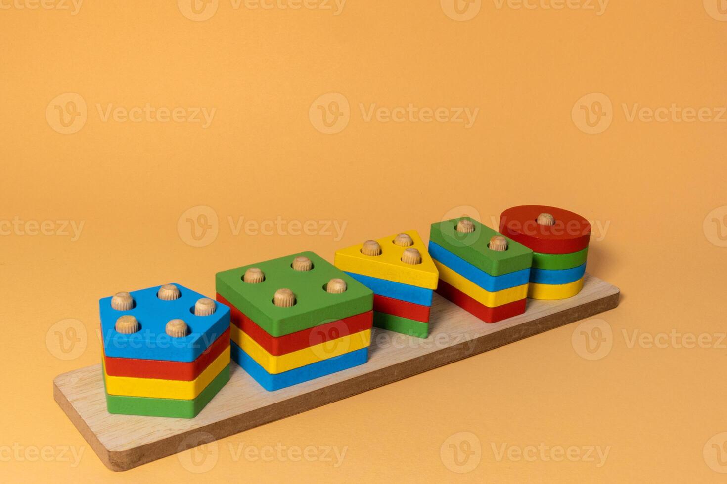 Sorter on neutral background. Multicolored logic sorter close up. Wooden educational logic toy for kid's. Montessori games for early child development. photo