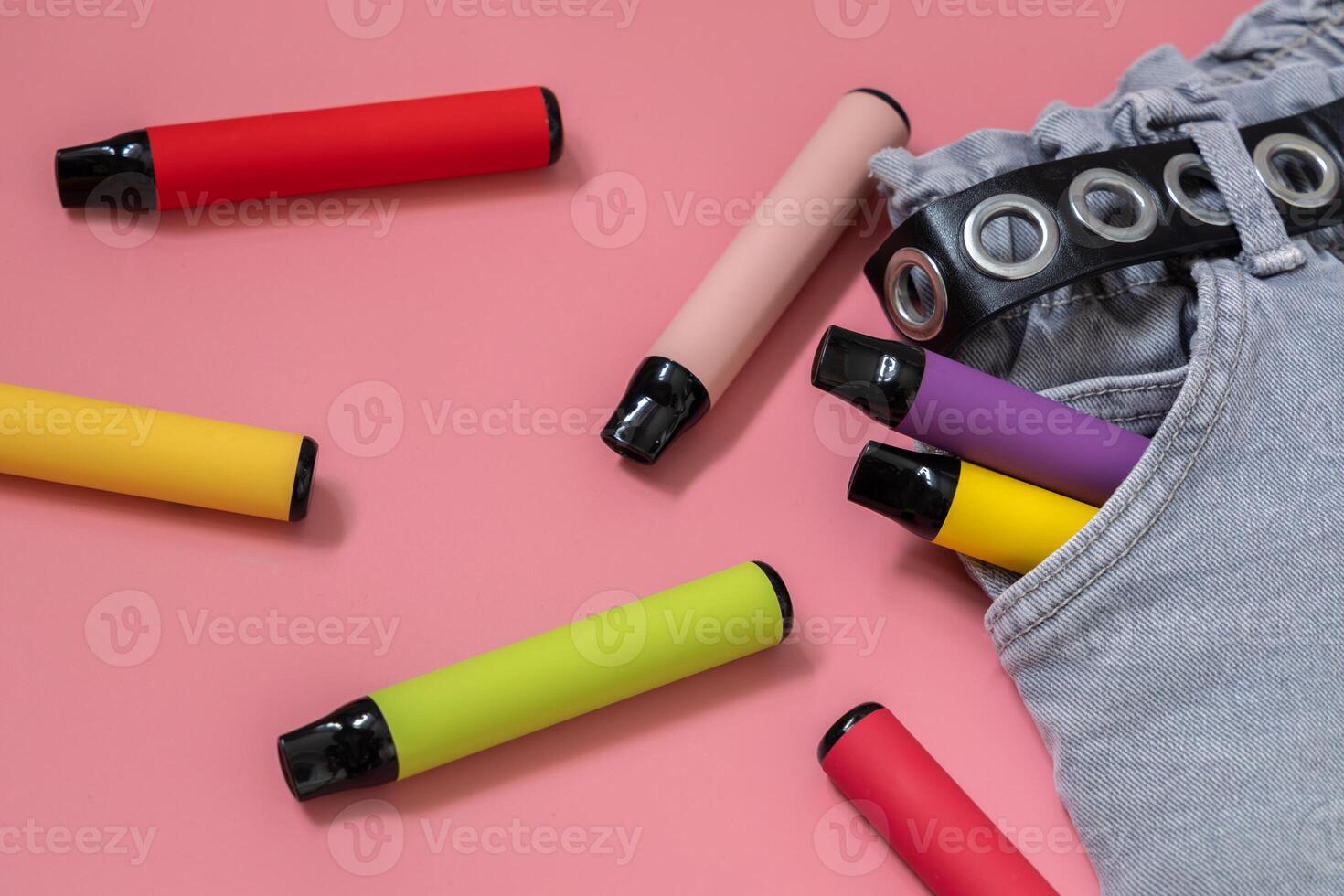 Colorful disposable vapor stick on a light background. Concept of modern e-smoking, vaping and nicotine, electronic cigarettes. photo