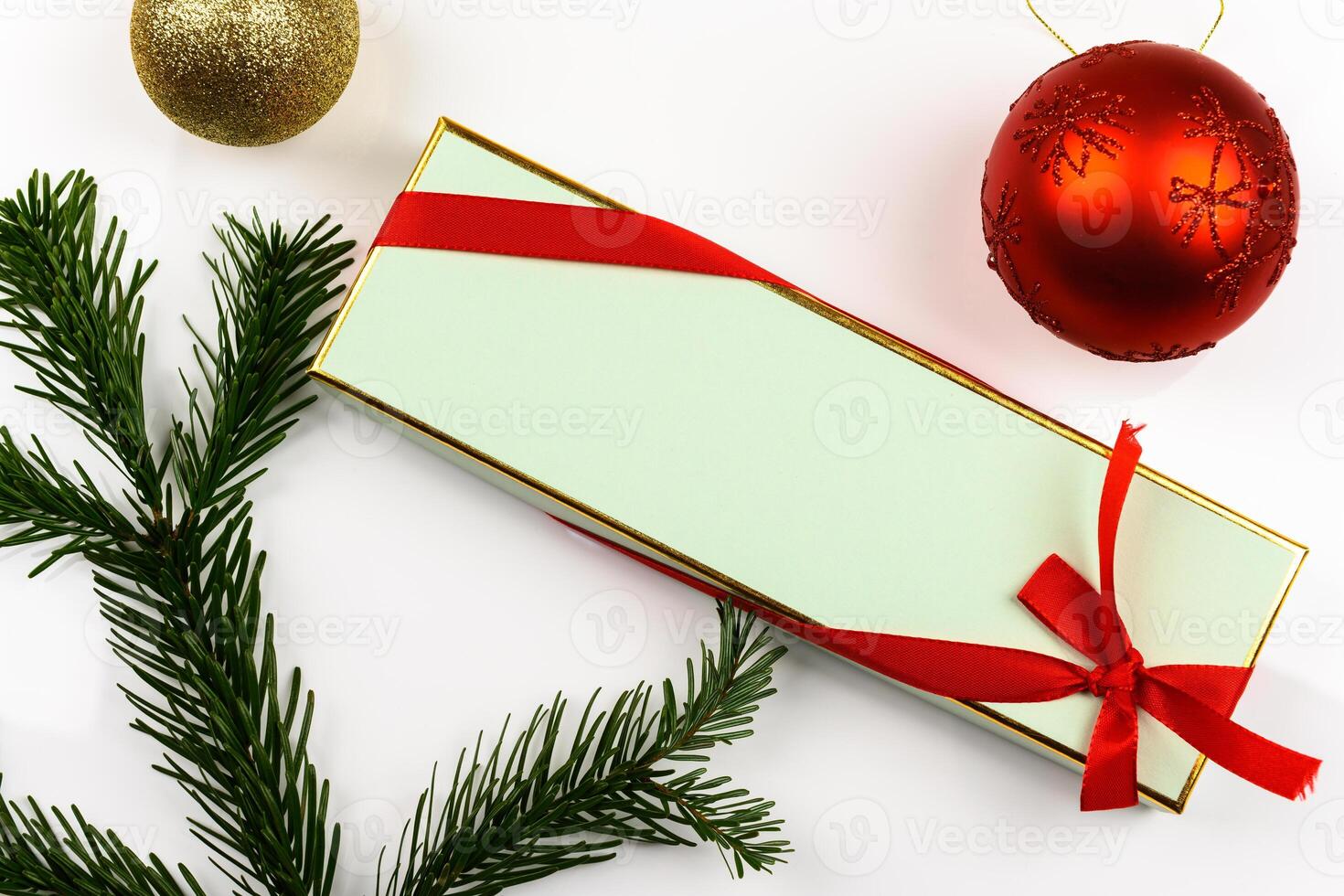 Beautiful gift box with a red ribbon on a white background photo