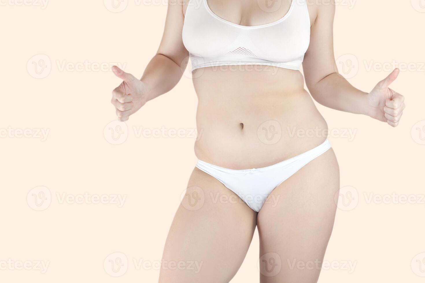 Body positive concept. A woman with excess belly fat loves her body. She is happy. photo