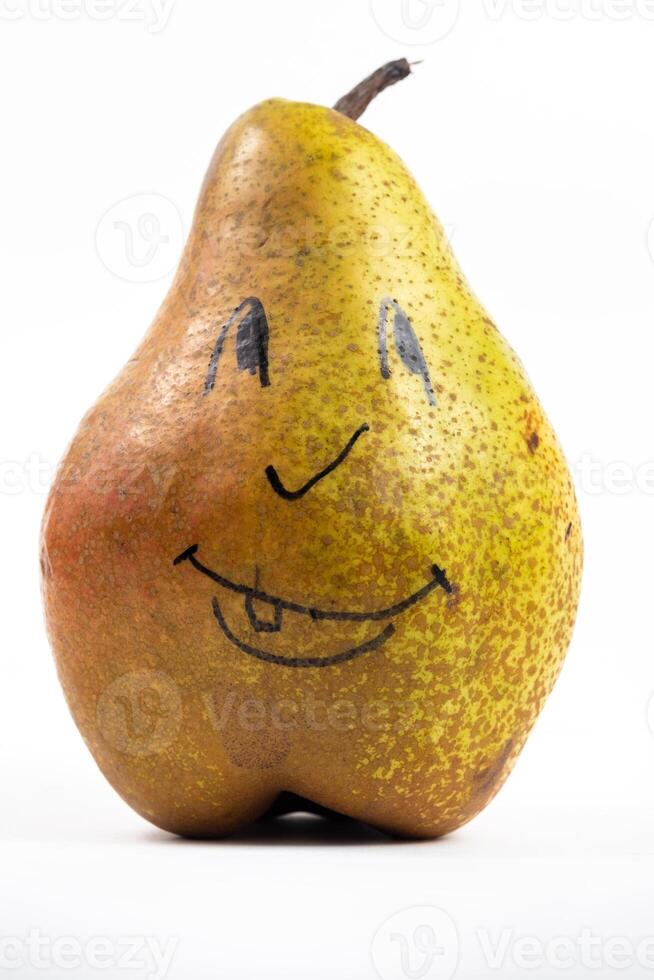 A large pear with a painted smiley face on a white isolated background photo