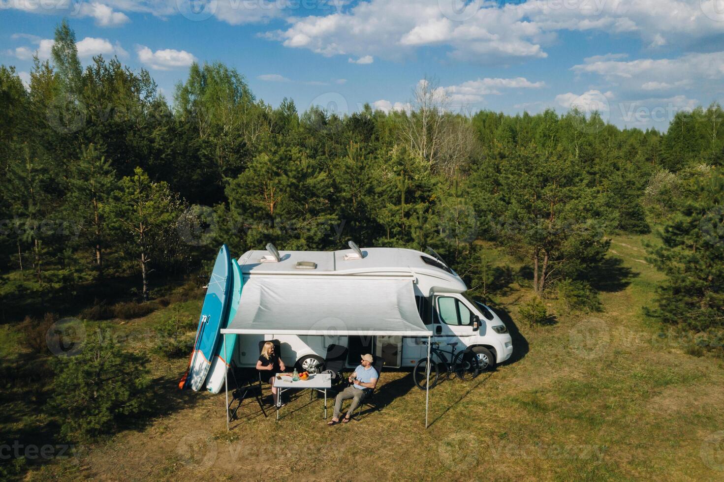 The family is resting in their race track located in the forest in sunny weather photo