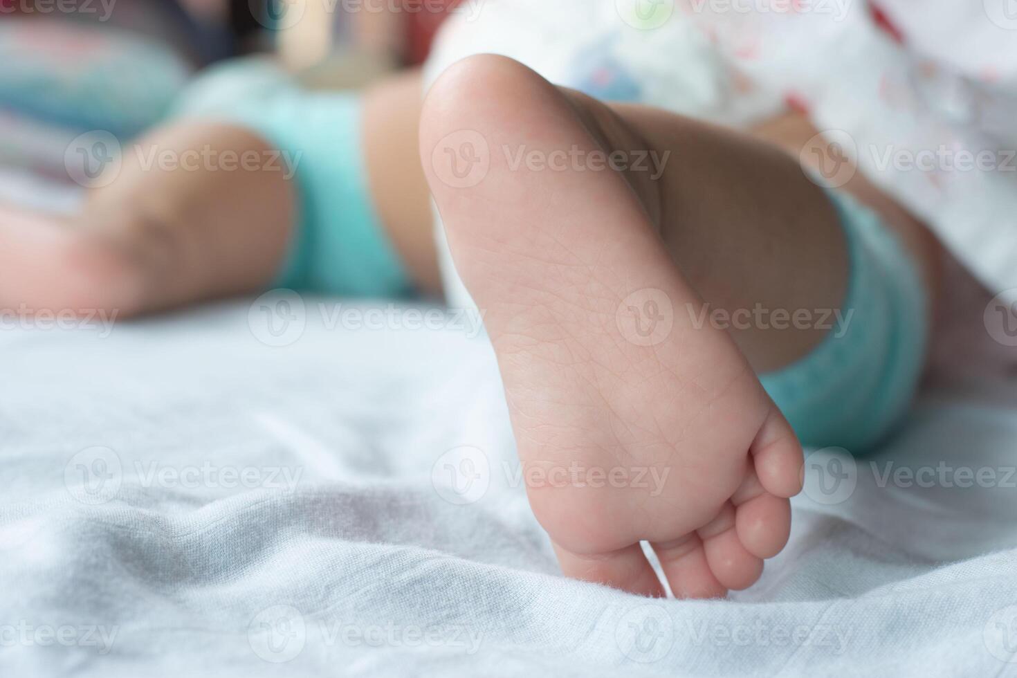 Close-up photo of the baby's soft feet on the mattress.