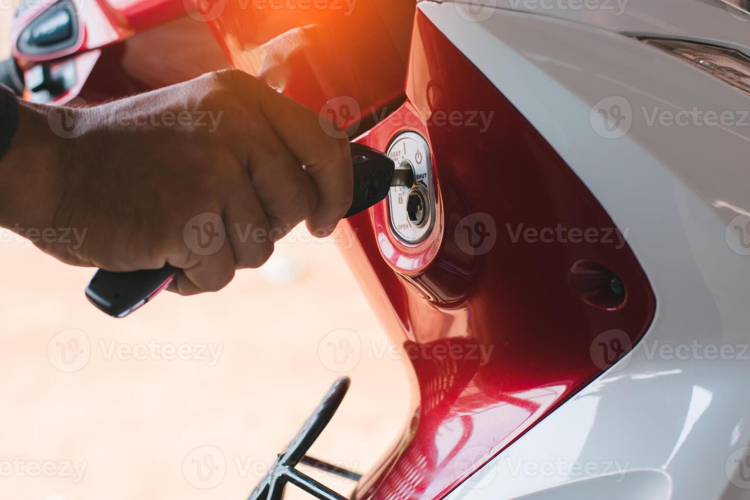 The man's hands are unfastened. Lock and start the car with the key. photo