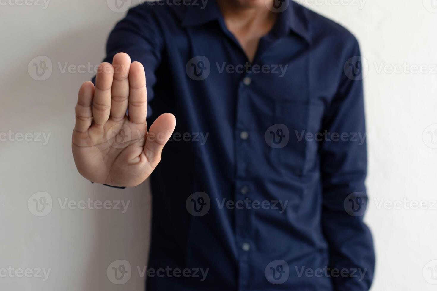 man showing hand to stop photo
