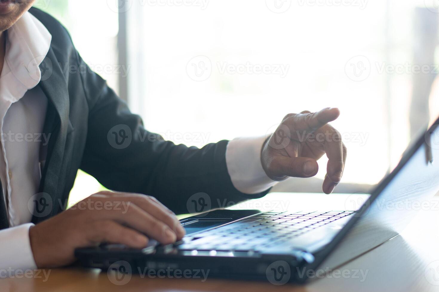 Businessmen or accountants work on computers and handle business documents at desks. photo