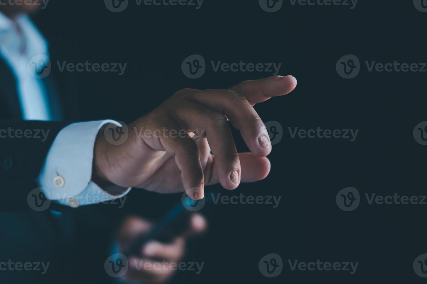 Businessman's hands working using a mobile phone photo