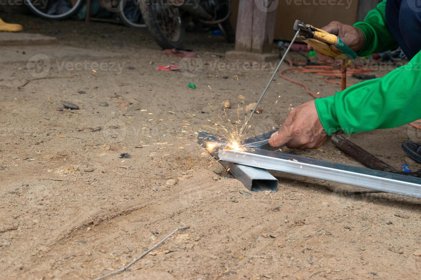 An industrial worker who welds steel with a lot of sparks in a factory. photo