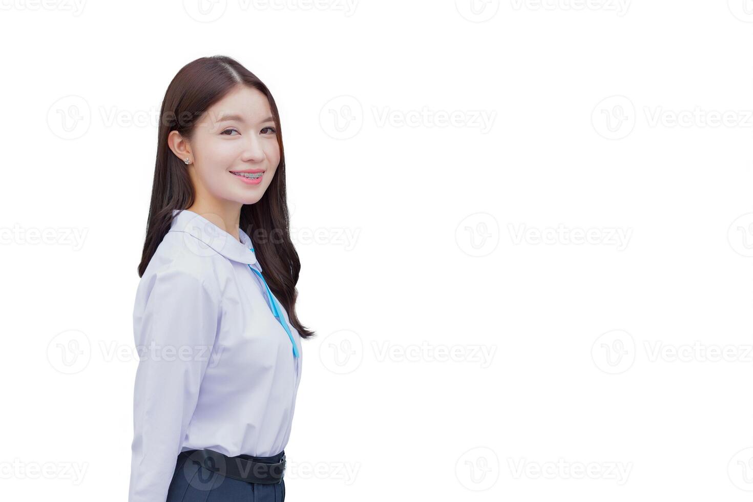 Beautiful Asian high school student girl in the school uniform with smiles confidently while she looks at the camera happily while isolated white background. photo