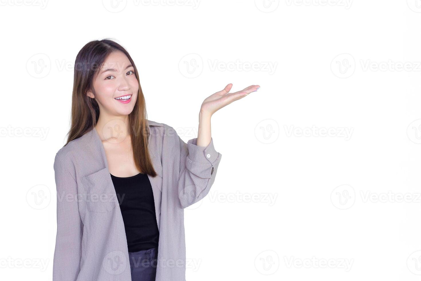 Beautiful young Asian woman long brown hair in black shirt is acting hand shows as presenting something in hospital while isolated white background. photo