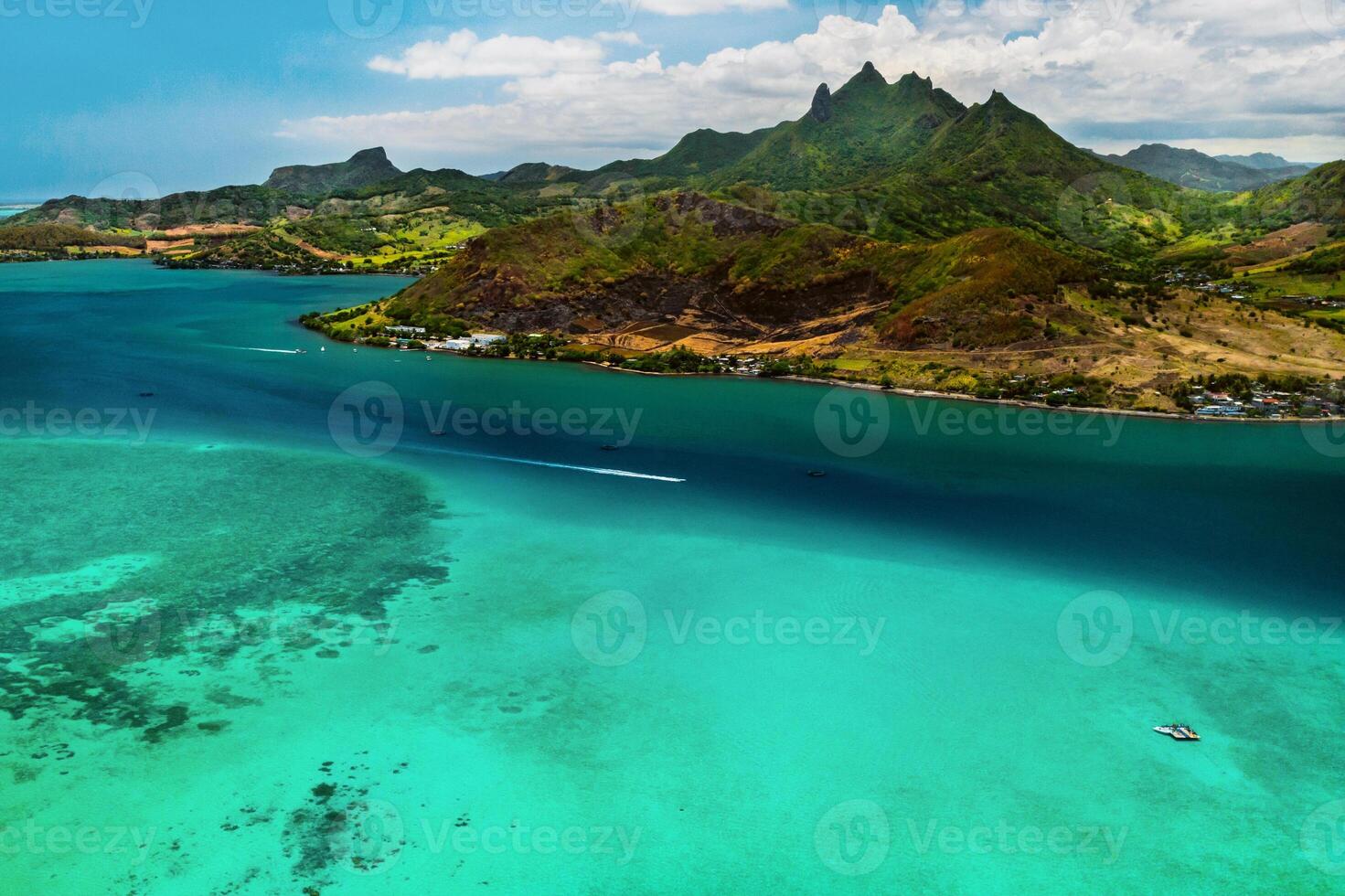 Aerial picture of the east coast of Mauritius Island. Beautiful lagoon of Mauritius Island shot from above. Boat sailing in turquoise lagoon photo